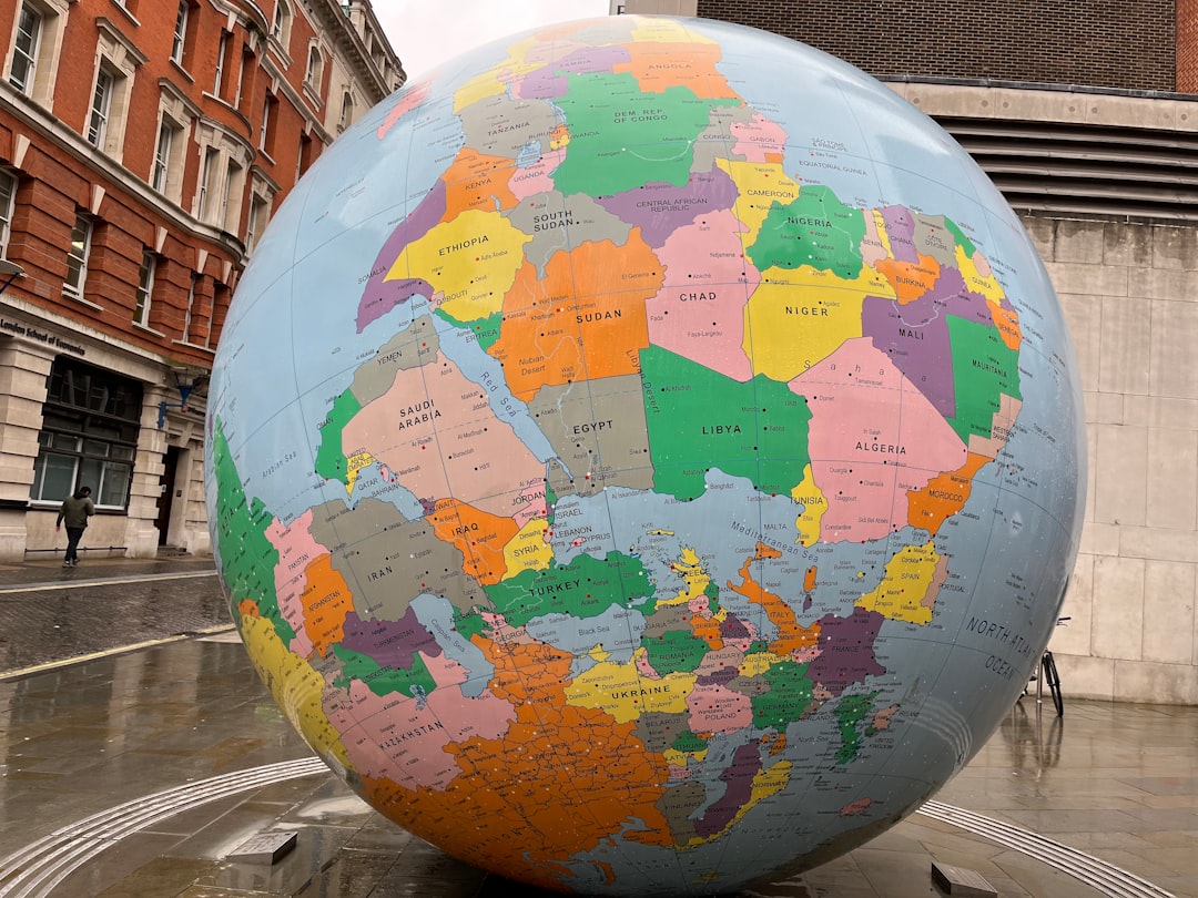 a large globe sitting in the middle of a street